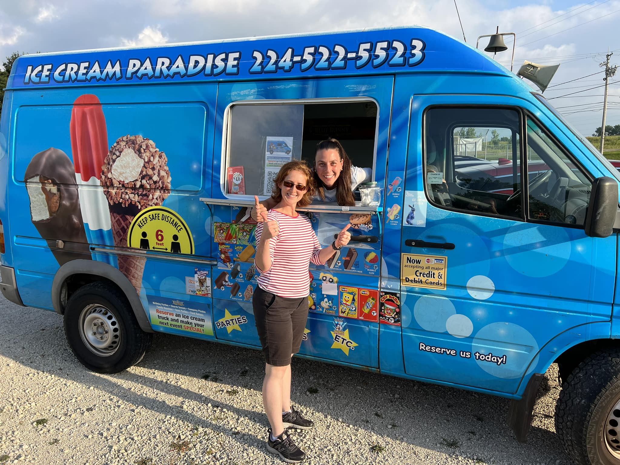 Side view of Ice Cream Paradise truck showing colorful branding and menu
