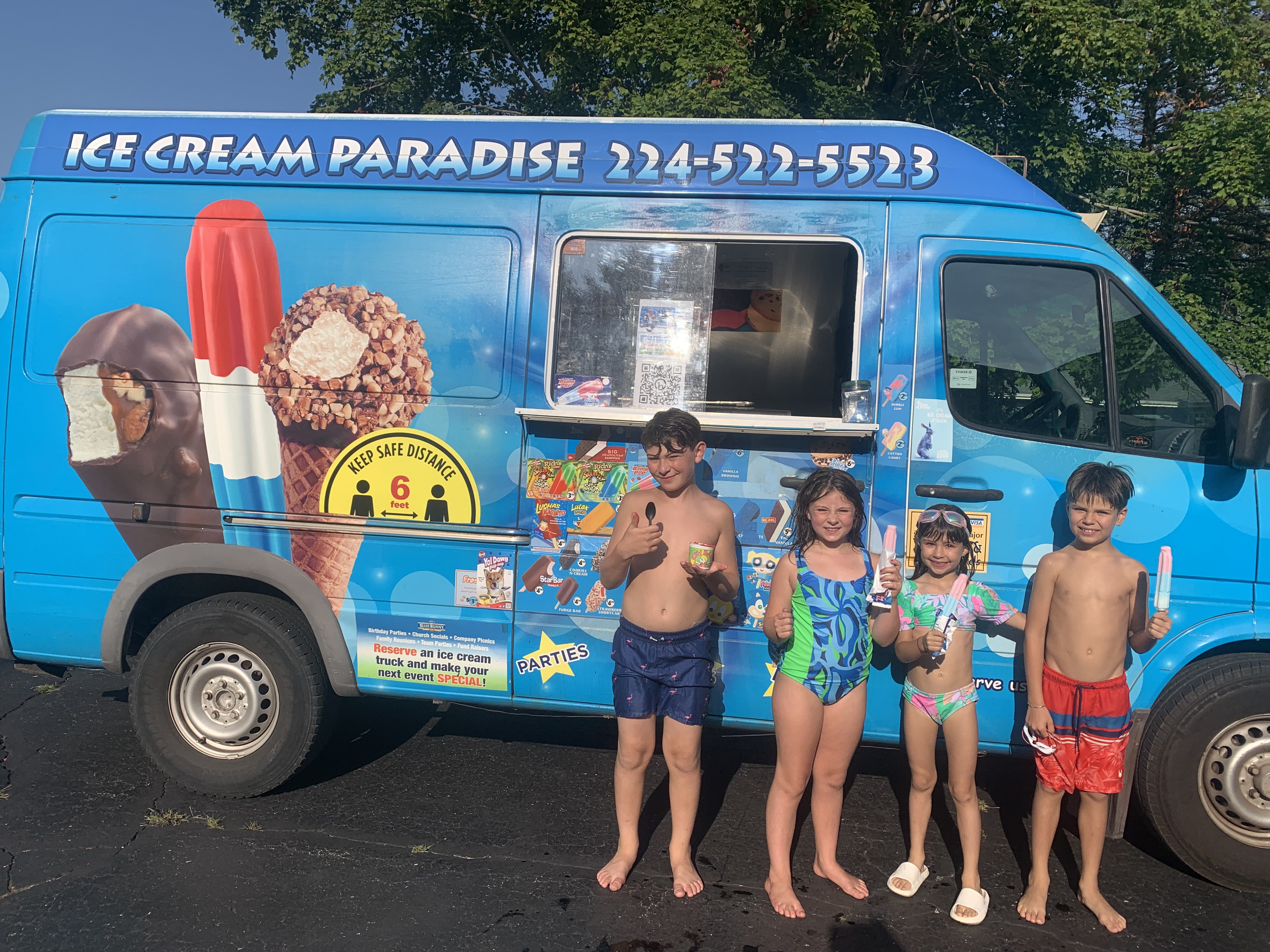 Customers enjoying ice cream from Ice Cream Paradise truck