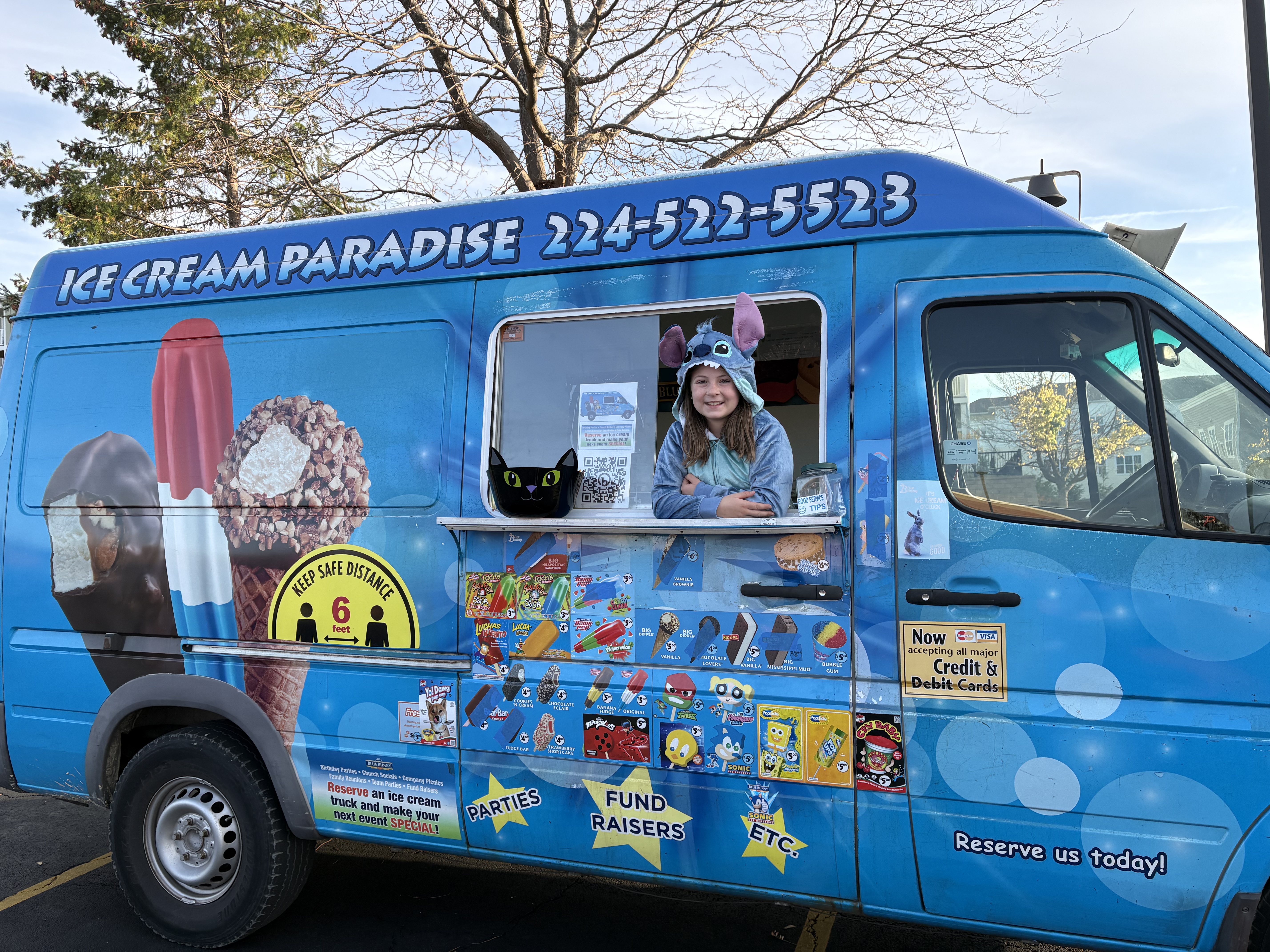 Happy customers gathered around Ice Cream Paradise truck